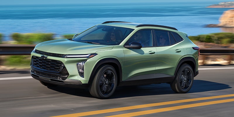 A seafoam green 2024 Chevy Trax driving on the highway near McGregor, TX