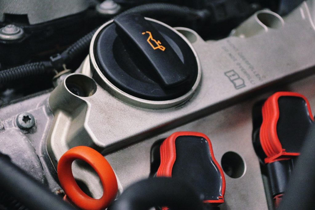 Close up image of an oil cap under a Chevy hood, in the garage at Jim Turner Chevrolet in McGregor, TX.