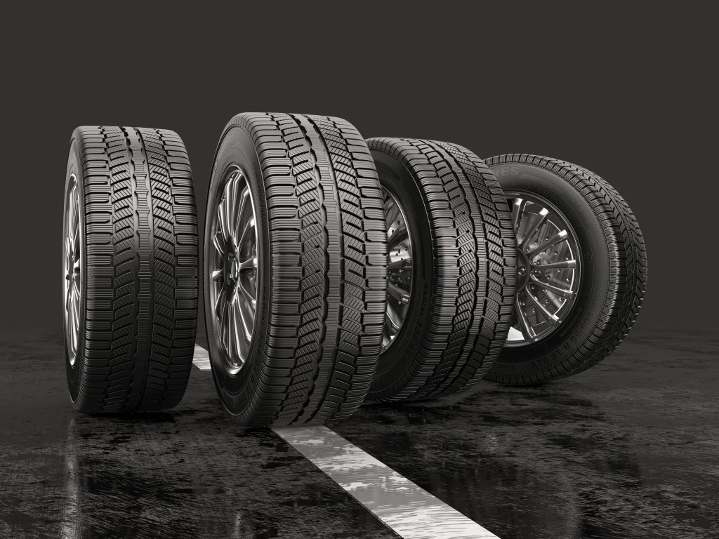 Four all-new tires and rims standing vertically next to each other. - Jim Turner Chevrolet McGregor, TX